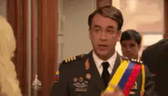 President Sandoval points to his sash