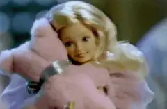 Barbie doll hugging pink teddy bear