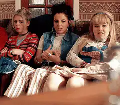 Three women on a couch looking disgusted