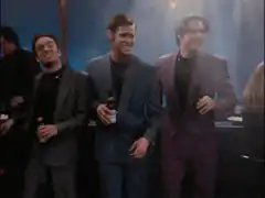 Three men laughing at a party