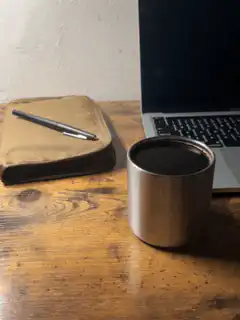coffee cup on desk with laptop