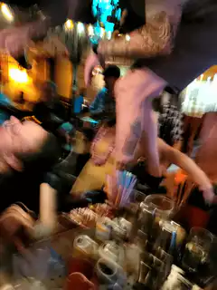 tattoo artist working on woman at bar