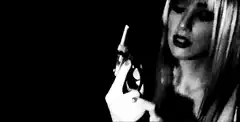 Blonde woman fires a revolver