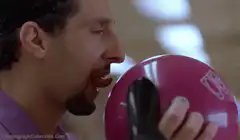 Man licking pink bowling ball