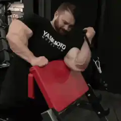 Bodybuilder doing preacher curls