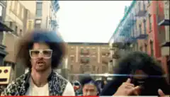 Two men with afros running down a city street