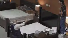 man jumps on mattress in furniture store