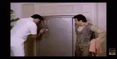 Two men opening a large metal safe