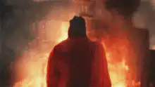Man standing in front of fire