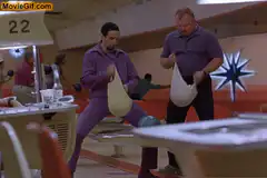 Two men holding plastic bags in a diner