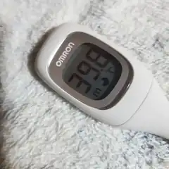 Omron thermometer showing 37.3 degrees