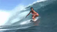 Woman surfing in pink bikini