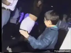 Kid dancing with woman in club