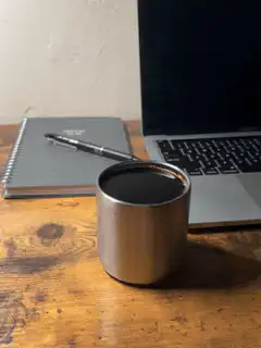 coffee cup on desk with laptop