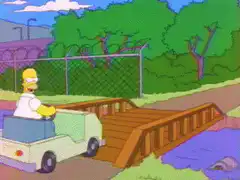 Homer Simpson drives over a bridge that explodes