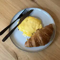 croissant and cheese omelette on plate