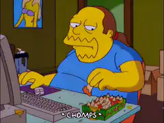 Carl Chryniszzswics eating chips at computer