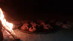Buns baking in a wood-fired oven