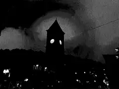 Silhouette of clock tower at night