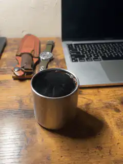 coffee cup on desk with laptop