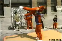 Man lifting woman in orange outfit