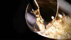 golden liquid pouring into glass