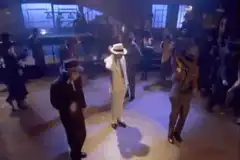 Men in suits doing the moonwalk
