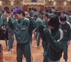 Squid Game players dancing in green tracksuits