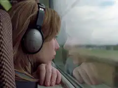 girl listening to music on train