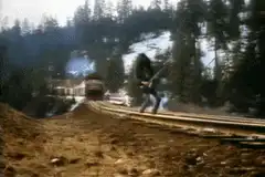 guitarist plays on train tracks