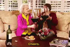 Betty White and friend toast with giant wine glasses