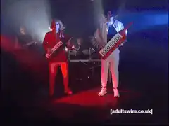 80s band playing keytar on stage