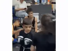 Young boy boxing with serious face