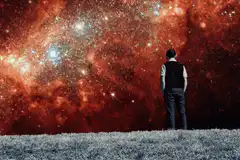 Man watching shifting colorful nebulae