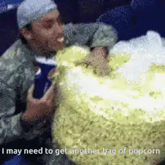 Man eating popcorn with popcorn in nose