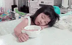 Toddler eating cereal with disgusted face