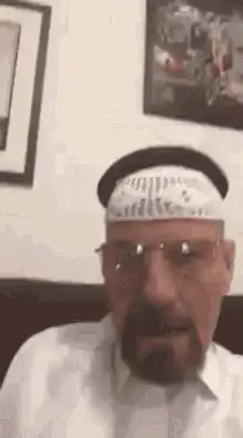 Man in kufi nodding and talking