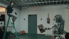 Robot hands man a box on a ladder