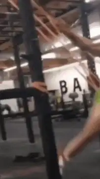 Woman in green bikini doing pull-ups