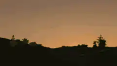 Sun rises revealing a smiling face