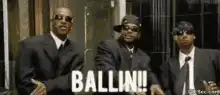 Three men in suits ballin