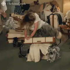Woman struggles to close overflowing suitcase