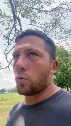 Man looking up with surprised expression outdoors
