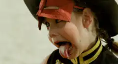 Girl in pirate costume sticking tongue out