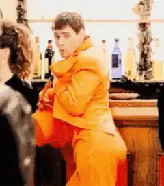 Man in orange suit wiggling his butt