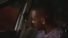 Man in car smirking