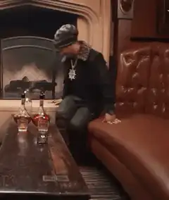 T-Pain laughing on a couch