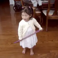 Toddler plays with hula hoop