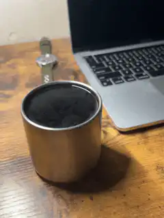 Steam rising from a metal cup