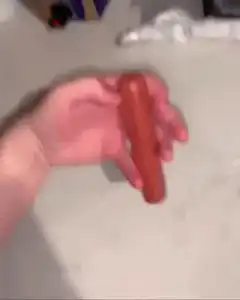 hand flipping a sausage